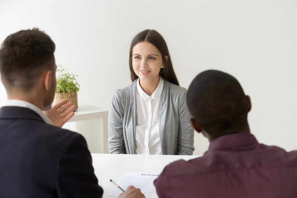 confident-applicant-smiling-job-interview-with-diverse-hr-managers_1163-4643
